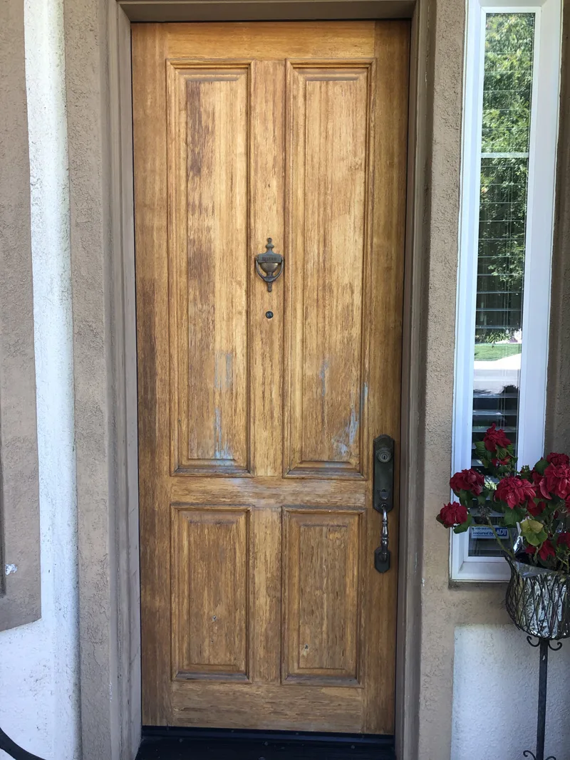 Front door before staining, weathered and faded