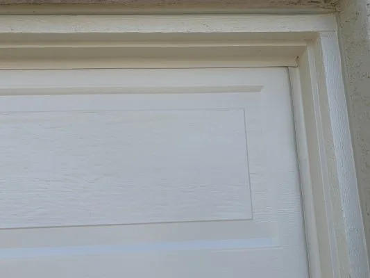 Finished garage door after stripping paint to the aluminum