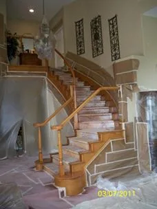 Staircase wood railing before staining, natural unfinished wood